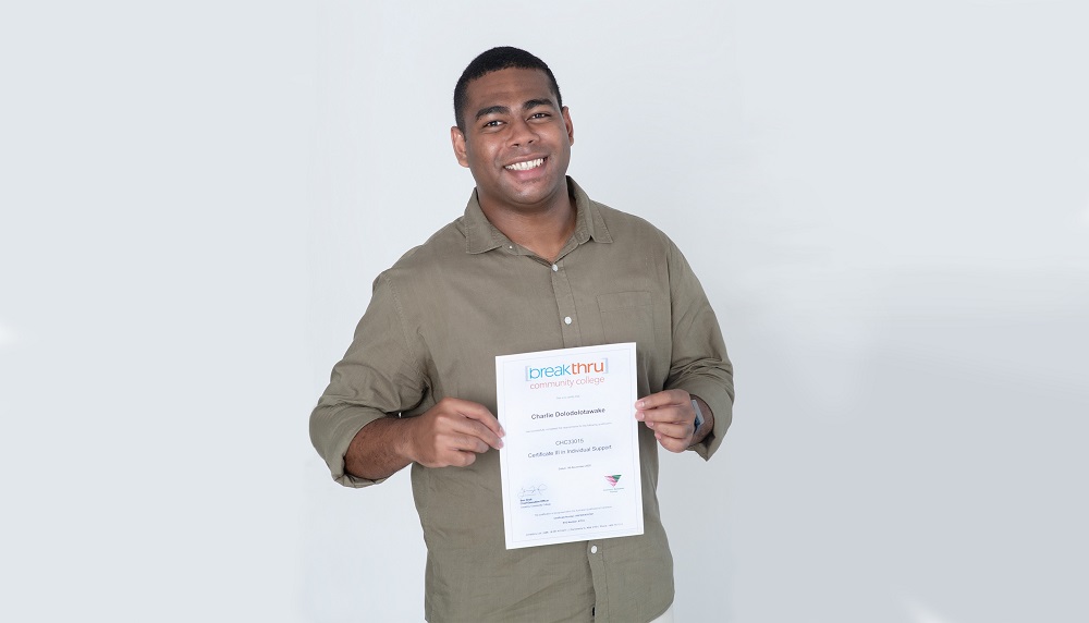 Charlie holding his certificate for Equity VET Student of the Year