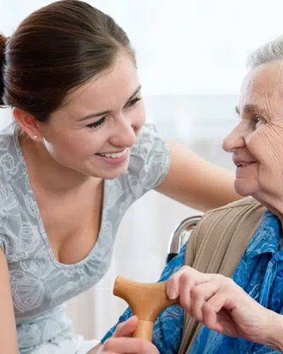 A graduate of an aged care course in NSW assisting a patient