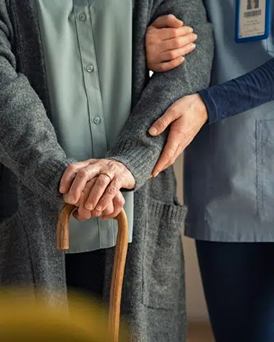 An aged care worker assisting an elderly resident